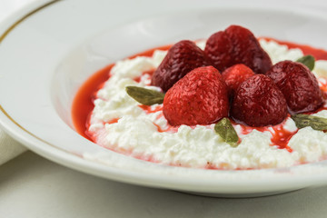 cottage cheese with strawberry sauce and fresh berries