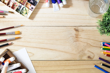 Hero Header Concept a desk of artist color pencils and paper on wood table with vintage tone