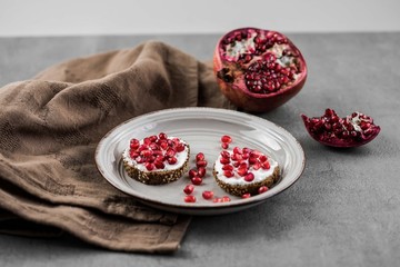 bread with cream cheese and pomegranate seeds.