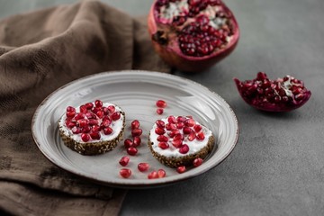 bread with cream cheese and pomegranate seeds.