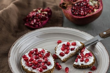 bread with cream cheese and pomegranate seeds.