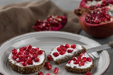 bread with cream cheese and pomegranate seeds.