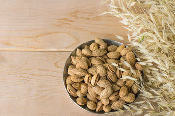 Nuts on the background texture of the wood. Almonds and peanuts.