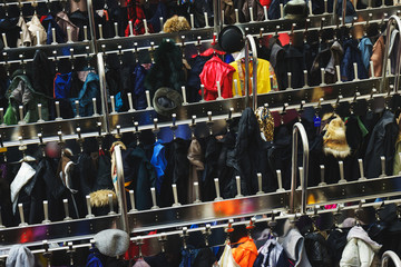 Top view of a large number of different clothes on hangers. Selective focus.