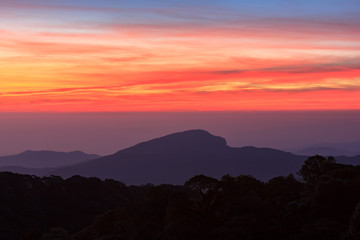 Beautiful Colorful Sunrise and Silhouette Mountain on the top of mountain in Thailand 
