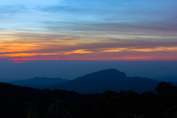 Beautiful Colorful Sunrise and Silhouette Mountain on the top of mountain in Thailand 
