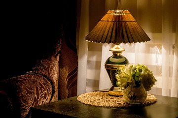 Cozy bedroom interior with bedside lamp
