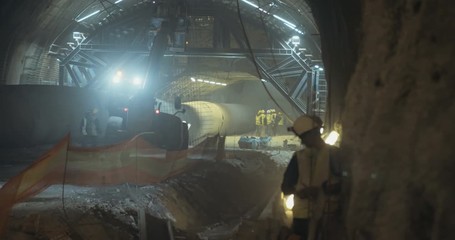 Construction workers in a large tunnel during construction and excavation