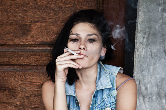 Sad woman smokes and crying 