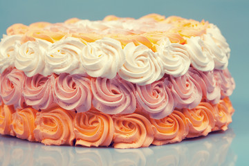 Festive ombre white pink orange cream cake