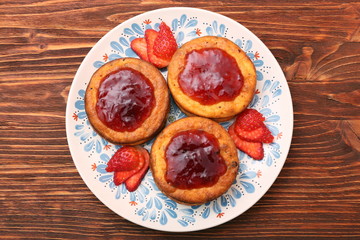 Cottage cheese patties with strawberry jam.