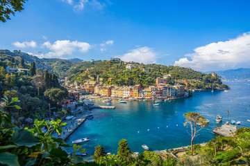 Fototapeta na wymiar PORTOFINO, ITALY, APRIL 8, 2017 - Panoramic view of Portofino, an Italian fishing village, Genoa province, Italy. A tourist place with a picturesque harbour and colorful houses