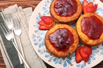 Cottage cheese patties with strawberry jam.