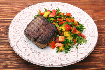 Grilled beefsteaks and vegetables