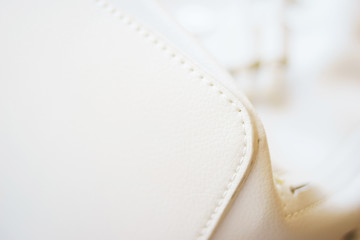 White leather and details of seams close-up. Things made of leather, texture and details of the...