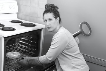 Woman cooking in the kitchen, wind up key in her back