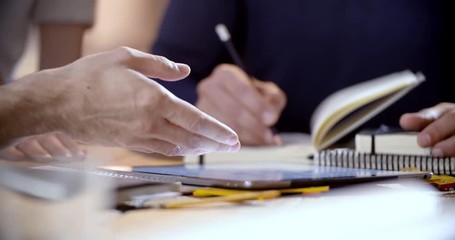 Creative business team work meeting an at agency office. details on hands working on design project idea on tablet. 4k indoor technology low angle video - Powered by Adobe