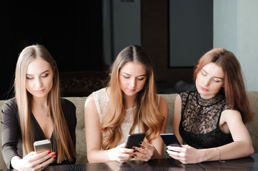 Young caucasian women using phone and saying no to life. Smartphone addiction concept