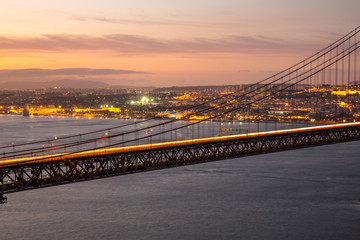 Sunset over the '25 of April' Bridge in Lisbon, Portugal.