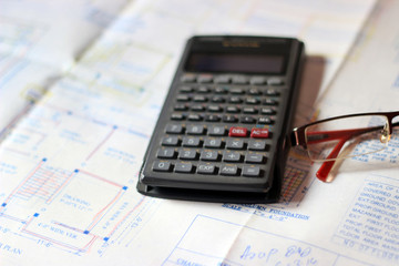 Calculator and building plans. Building planes for a new house, isolated.