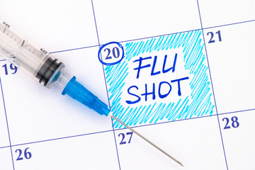 Reminder Flu Shot in calendar with syringe