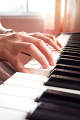 Fototapeta premium Woman hands playing piano. Music and art background.