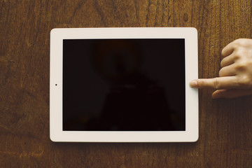 tablet pc on old wood table background