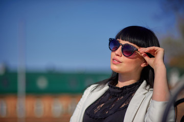 Beautiful young girl with black hair, sunglasses. Youth, happiness, summer sunny day, portrait