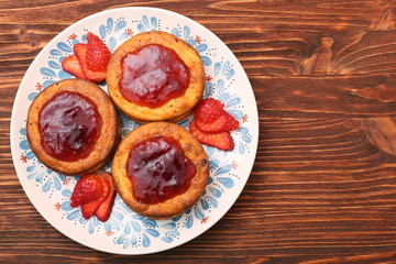 Cottage cheese patties with strawberry jam.