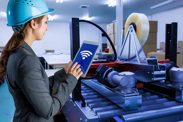 young woman using tablet PC in factory. industrial technology concept. factory automation....