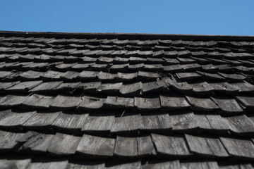 old wooden roof on a background of blue sky
