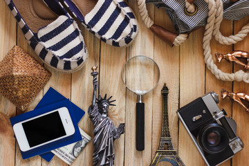 Slippers, camera, phone, miniature of the statue of liberty and Eiffel Tower