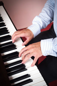Man hands playing piano. Music and art background. Favorite music instrument of classic music.