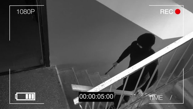 surveillance camera caught the robber in a mask with a crowbar.