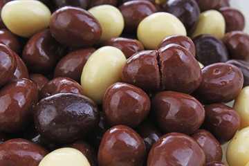 Dark and dairy chocolate balls.  Chocolate drops as background texture pattern. Bon bons.