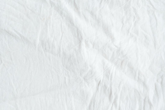 Wrinkled white cotton fabric texture background, wallpaper