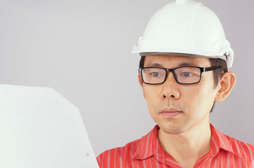Engineer wear red shirt is looking at document white background