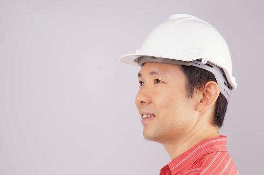 Happy engineer wear red shirt and hat look to side