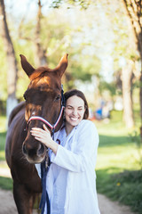 Vet petting a horse outdoors at ranch. 