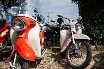 Retro old scooter motocycles on meet of classic cars