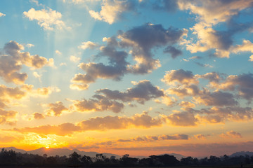 Obraz premium Dramatic sky include cloud, sunset or sunrise, outdoor space and horizon or skyline. Colorful with yellow, orange and blue color at evening in autumn. For scene, backdrop, background and wallpaper.