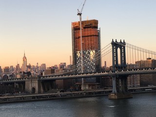 Fototapeta na wymiar Manhattan Bridge with skyline and skyscraper building site in the background