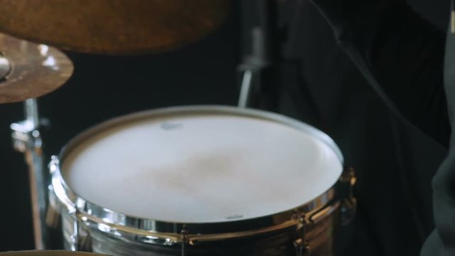 Studio rehearsal of man playing on drums closeup