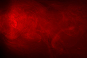 Fototapeta na wymiar Red Smoke on a black background