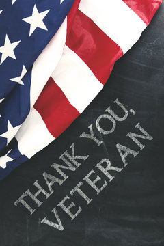 American flag near handwriting of thank you, veteran