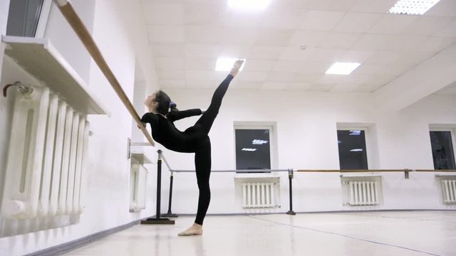 graceful girl practicing ballet in the Studio, slow motion , does pirouettes