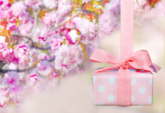 Beautiful wrapped gift box with spring blossoms