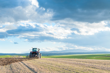 Fototapeta premium tractor in the lands along with gear for work.