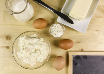 Bechamel in a transparent bowl on wooden background - top view