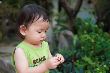 Toddler boy in green vest